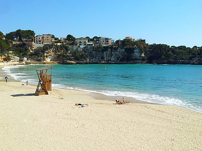 people on shore facing ocean thumbnail