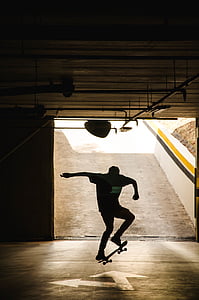 silhouette of man kicking skateboard thumbnail