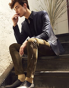 man sitting on brown wooden staircase thumbnail