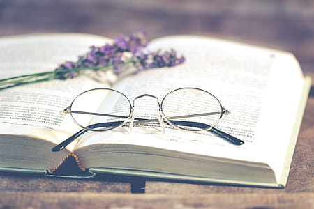 Silver-colored Framed Eyeglasses on Open Book thumbnail