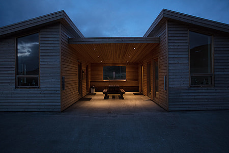 white and brown wooden house with opened light thumbnail