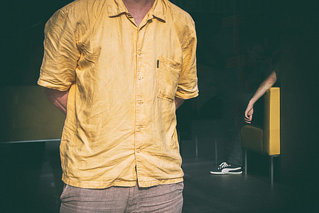 Cropped image of a man dressed in a yellow shirt. Image captured in Linz, Austria thumbnail