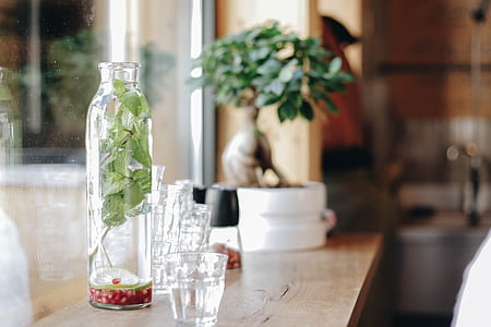 clear shot glasses on top of brown wooden table thumbnail