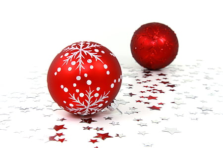 two red Christmas baubles on white surface thumbnail