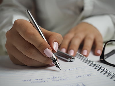 person writing with their right hand using fountain pen thumbnail