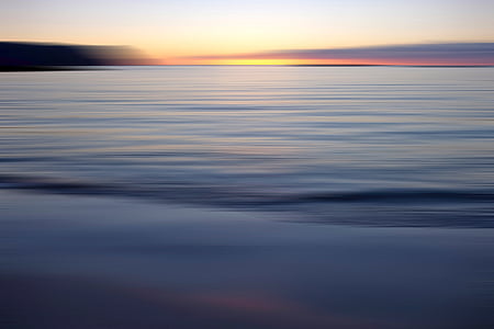 photo of body of water during sunset thumbnail