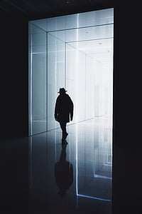 silhouette photography of person walking in hallway thumbnail
