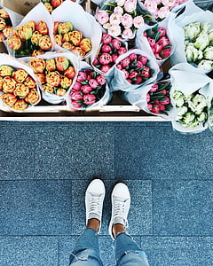 person standing beside flowers thumbnail