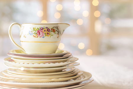 selective-focus photography of white-and-multicolored floral ceramic tea set thumbnail