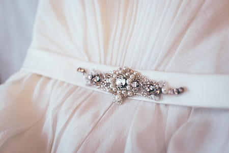 white cloth with silver-colored beads thumbnail