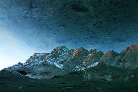 white snow covered mountain under grey sky thumbnail
