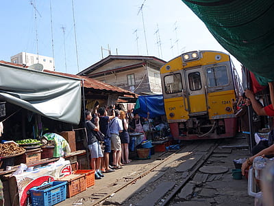 people standing beside railway near train thumbnail