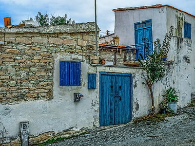 white concrete house with blue door thumbnail