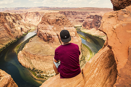 man sitting on cliff rock thumbnail