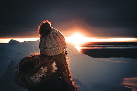 woman sitting on top of mountain during sunrise thumbnail