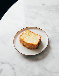 sliced of cake with saucer on table thumbnail