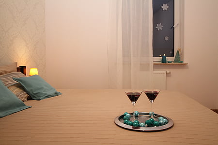 two cocktail glasses on bed thumbnail