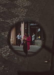 motorcycle side mirror view of woman using smartphone while walking thumbnail