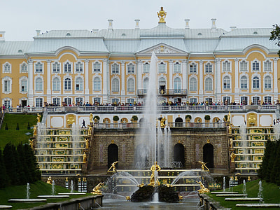 time lapse photography of fountain beside white and brown house thumbnail