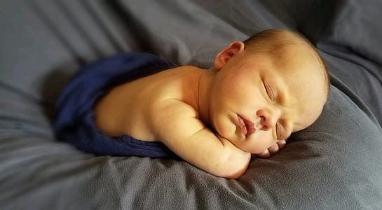 baby in blue swaddle thumbnail