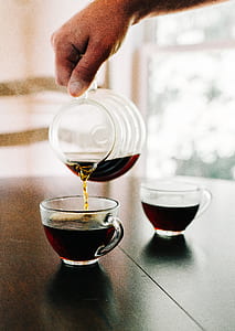 person pouring tea on tea glass thumbnail