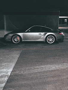 gray Porsche Boxster parked on the basement of a building thumbnail