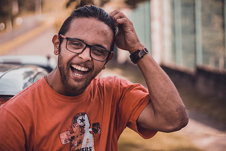 Selective Focus Photography of Man Smiling Putting Hands on Head thumbnail
