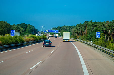 blue car traveling on road during daytime thumbnail