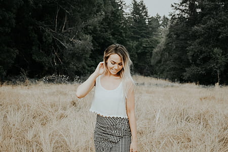 woman in white crop top standing of plant field thumbnail