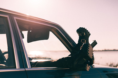 person wearing black boots lying inside vehicle thumbnail