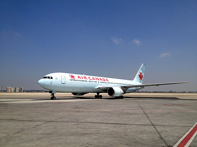 red Air Canada airliner under blue sky thumbnail