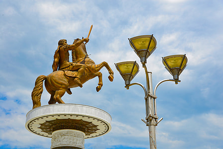 man riding horse statue near 3-fixture lamppost thumbnail