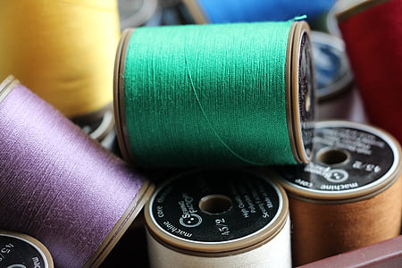 pile of assorted-color thread spools thumbnail
