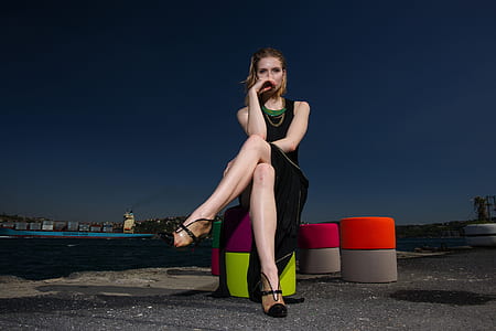 woman in black sitting on stool thumbnail