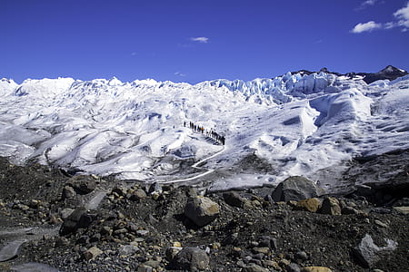 snow covered land under blue sky during daytime thumbnail