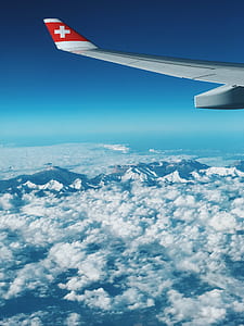 gray airplane wing above white clouds thumbnail
