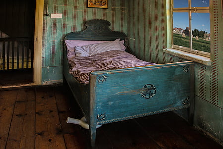 closeup photo of teal bed with pink bed sheet near window thumbnail