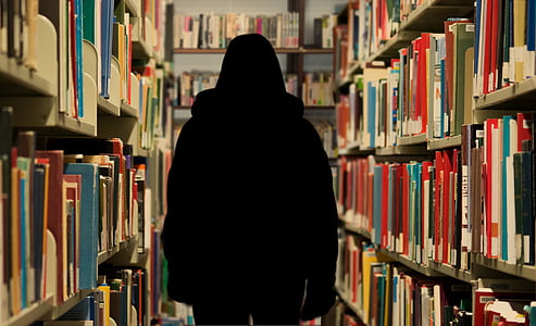 silhouette of person in between tall cabinets with folders thumbnail
