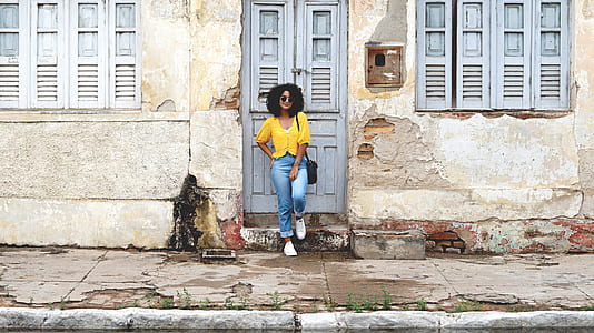 woman leaning on gray wooden door thumbnail