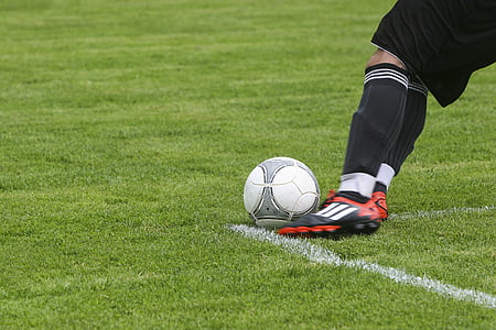person kicking soccer ball in a field thumbnail