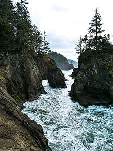 body of water between gray stone mountains thumbnail