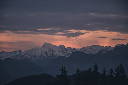photograph of mountain covered with snow during golden hour thumbnail