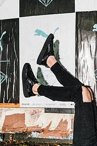 person wearing pair of black sneakers thumbnail