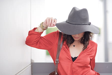 woman in red long-sleeved top wearing gray hat thumbnail