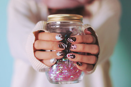 human holding clear glass jar thumbnail