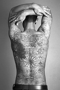 man with full back tattoo grayscale photo thumbnail