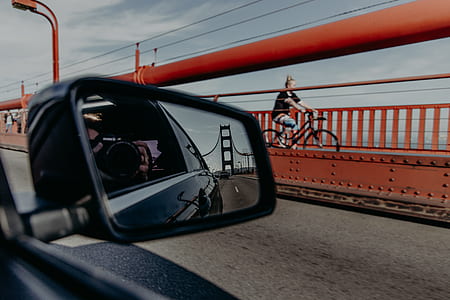 woman riding bike near road thumbnail