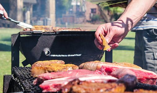 bunch of raw meats on black grill thumbnail