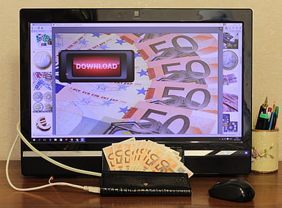 wallet with banknotes near flat screen computer monitor turned on thumbnail