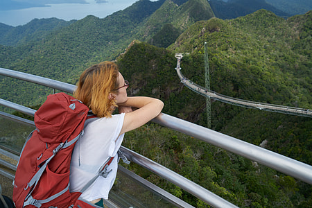 woman leaning on grey metal railing thumbnail